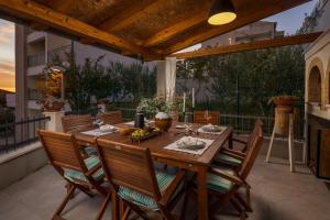 a wooden table and chairs on a patio at Villa Nono in Podstrana