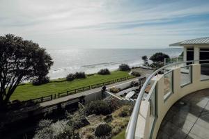 a view of the ocean from the balcony of a house at Oceanfront Retreat - Beach Access - 2BR Bell Block in New Plymouth