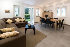 a living room with a couch and a dining room at Lenno Dolcelago in Lenno
