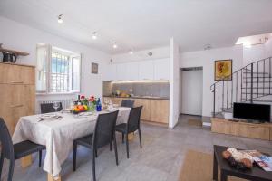 a kitchen and dining room with a table and chairs at Lenno Dolcelago in Lenno +24 photos