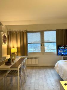 a bedroom with a bed and a desk and a table at Pieno Centro in Basiglio