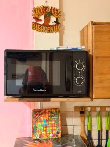 a microwave sitting on top of a kitchen counter at GITE LE FILAO in Le Lorrain