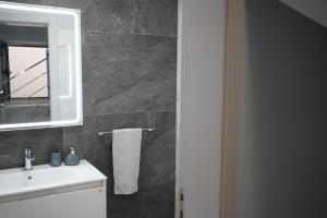 a bathroom with a sink and a mirror at Pauloldtown - Local experience w rooftop n jacuzzi in Paul do Mar +22 photos
