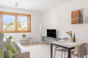 a living room with a table and a tv at Apartment in Serravalle in Vittorio Veneto