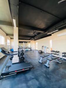 a gym with several treadmills and cardio machines at Bakal Luxury condos in Tulum