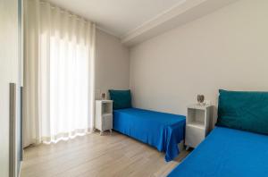 a bedroom with two beds and a window at Micabalù Luxury Apartment in Marina di Camerota +38 photos