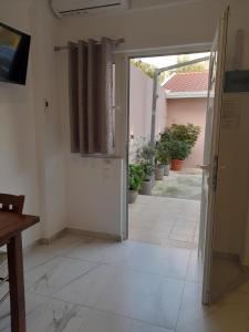 an open door to a room with a patio at VANGJELIS HOTEL in Himare