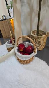 a basket of fruit sitting on a table next to a mirror at Sleep Owl Surat Thani in Surat Thani