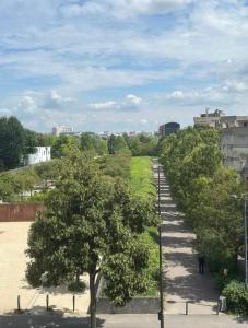 a row of trees on a sidewalk in a city at Petit nid calme à 2 pas de Paris in Ivry-sur-Seine