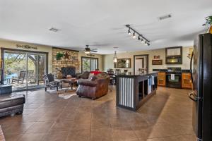 a large living room with furniture and a kitchen at 2 Creeks in Wimberley +22 photos