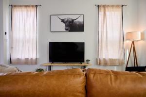 a living room with a couch and a television at A Stunning Escape in Canyon Lake