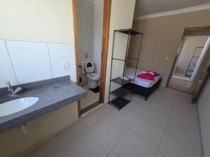 a bathroom with a sink and a toilet at Hostel Araguaia in Goiânia