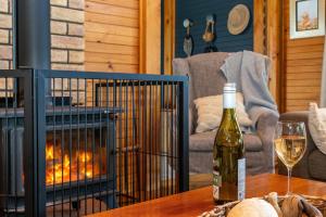 a bottle of wine on a table with a fireplace at The Dunes Hideaway in Dolphin Sands