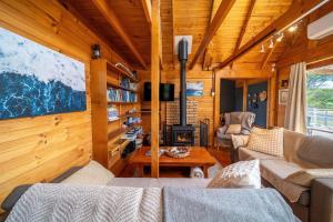 a living room with a fireplace in a log cabin at The Dunes Hideaway in Dolphin Sands