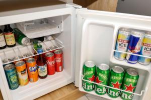 an open refrigerator filled with drinks and sodas at Hedonist Spa Jacuzzi Centar Free private parking in Sarajevo