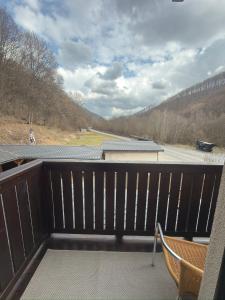 a balcony with a chair and a view of a road at Hrochoťský mlyn in Hrochoť