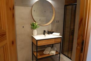a bathroom with a sink and a mirror at Spokojny Potok Sopot - AFRA GROUP in Sopot +10 photos
