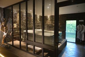 a room with a window with a tub in it at L'Orchidée in Sévrier +13 photos