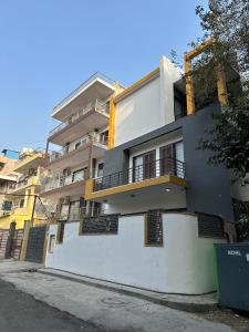 a white building with balconies on the side of it at Remix stays in Gurgaon