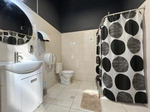 a bathroom with a toilet and a shower curtain at Hostel Bohemian in Montevideo +40 photos