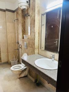 a bathroom with a sink and a toilet in it at Remix stays in Gurgaon +20 photos