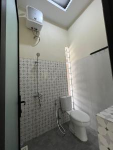 a bathroom with a toilet and a shower at Menata Villa Harmoni in Pakem +7 photos