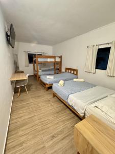 a bedroom with two beds and a desk and a desk at La Arteza Pacasmayo in Pacasmayo +74 photos