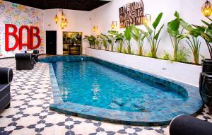 a large swimming pool in a room with a tile floor at BAB HOTEL Marrakech, Boutique Hôtel & SPA in Marrakesh