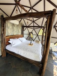 a bedroom with a wooden bed in a tent at Domo Alto del Monte in Alto del Monte +14 photos