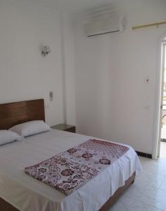 a bedroom with a bed with a brown and white bedspread at Nile Paradise Apartments in Luxor