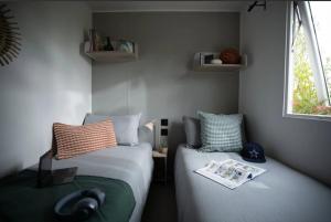 a bedroom with two beds and a window at Camping 3 étoiles - Piscine - ccbffbc in Saint-Denis-dʼOléron +34 photos