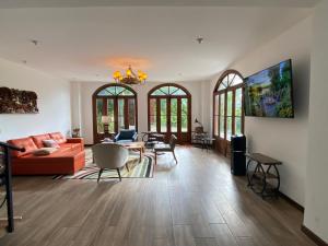 a living room with a couch and a table at Casa Colonial Maria Elena in Pereira