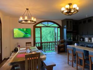 a kitchen and dining room with a dining table and a view at Casa Colonial Maria Elena in Pereira