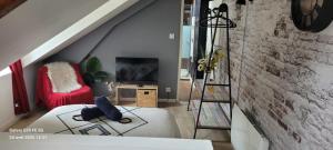 a living room with a staircase and a couch at Cocon industriel pour Nuits étoilées in Bourges