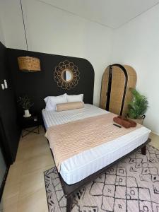 a bedroom with a large bed with a mirror on the wall at Menata Villa Harmoni in Pakem