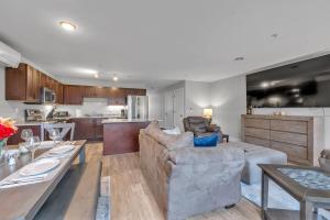 a kitchen and living room with a couch and a table at Modern Birmingham Retreat in Birmingham
