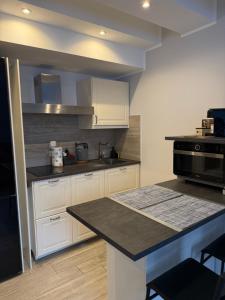 a kitchen with white cabinets and a black stove at Vista Lago in Basiglio