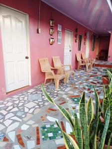 a room with chairs and a tile floor at Guest House Nena in Moyogalpa