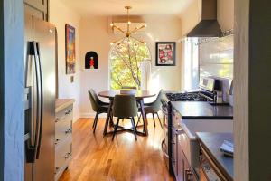 a kitchen with a table and a dining room at Ski, Shop & Explore: Walkable Midtown Reno Oasis! in Reno
