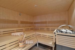 an empty sauna with wooden cabinets at Hotel Edelweiss in Itter
