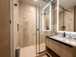 a bathroom with a glass shower and a sink at Casa La Aurora - Beachfront Studio and Rooftop Infinity Pool in Puerto Morelos +12 photos