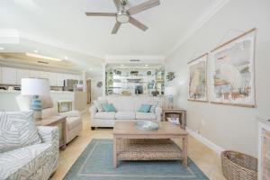 a living room with a couch and a table at Phoenix on the Bay 1206 in Orange Beach