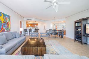 a living room with a couch and a table at Phoenix on the Bay 1528 in Orange Beach