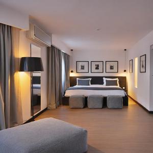 a bedroom with a large bed and a couch at BAB HOTEL Marrakech, Boutique Hôtel & SPA in Marrakesh