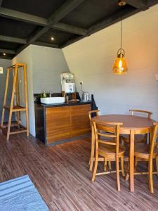 a kitchen with a table and chairs and a counter at A frame Riverston in Matale +5 photos