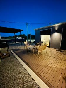 a deck with chairs and a bench on a building at La casa de Tokyo in Carmelo