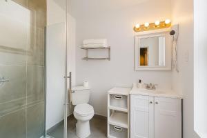 a bathroom with a toilet and a sink and a shower at Hoboken Studio 15 Min from Manhattan in Hoboken +8 photos