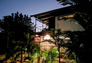 a house with a light on the side of it at Tiny Black Loft in Port Vila