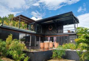 a large black house with a deck and balcony at Tiny Black Loft in Port Vila
