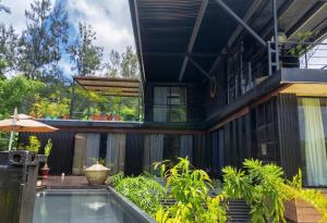 an external view of a house with a swimming pool at Tiny Black Loft in Port Vila +4 photos